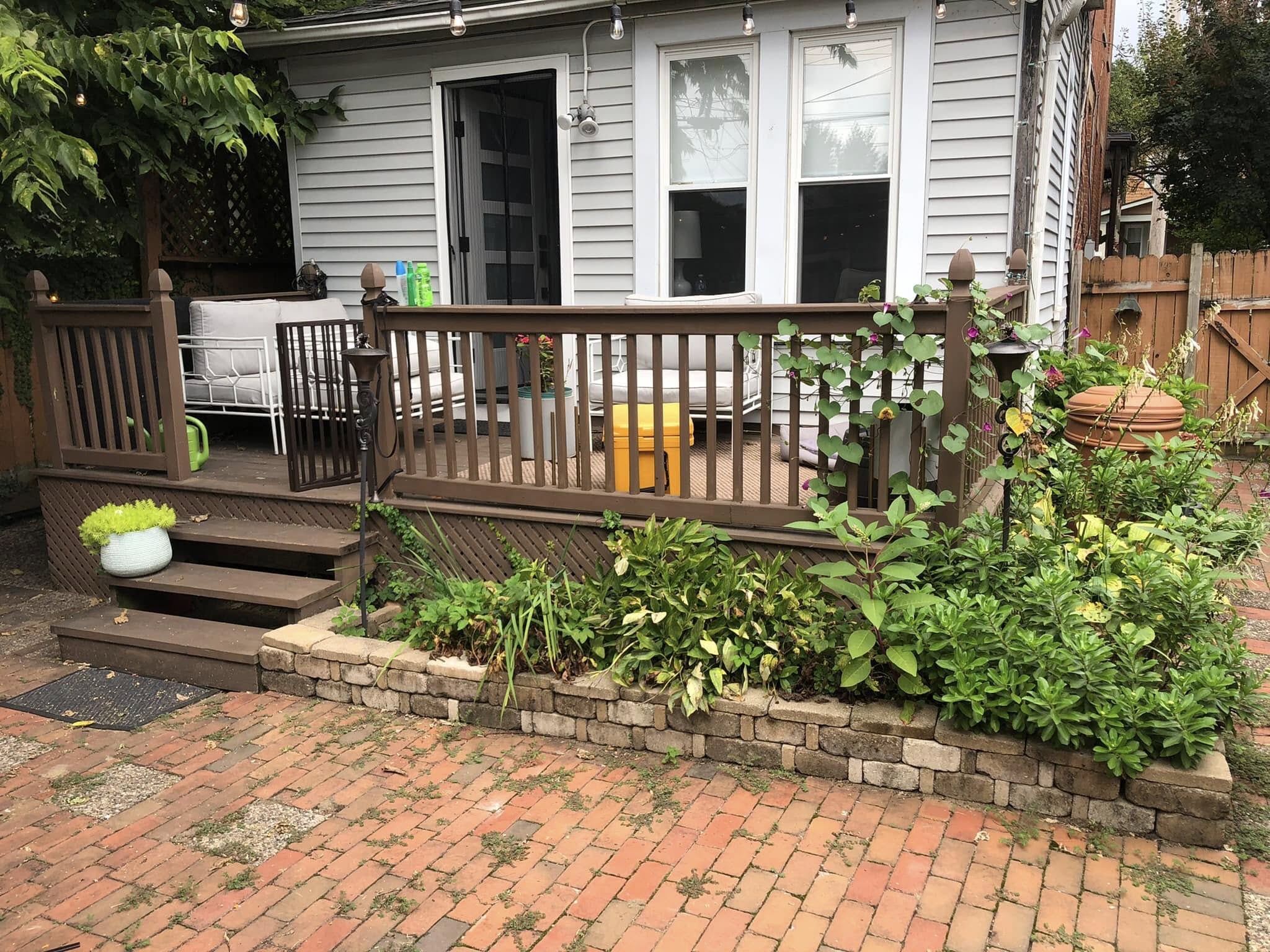Before: worn wood deck and faded siding on a Columbus home